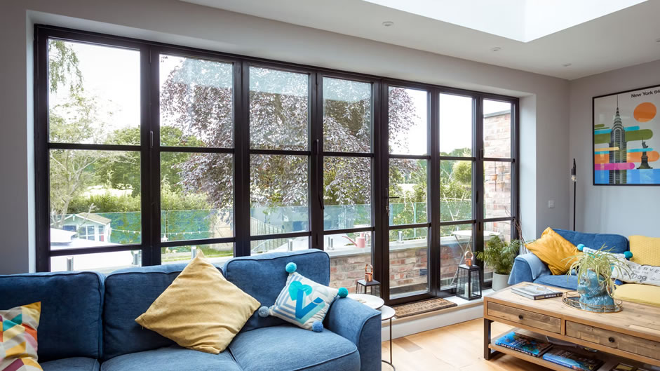 aluminium bifold doors in modern colourful living room, looking out to garden