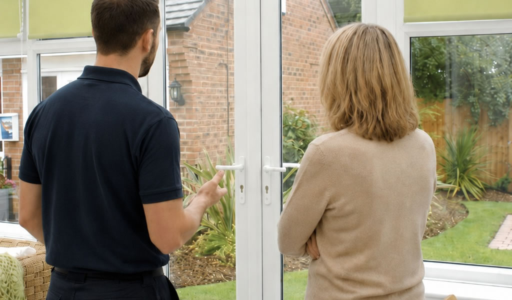 Installer in front of Eurocell french door talking to customer