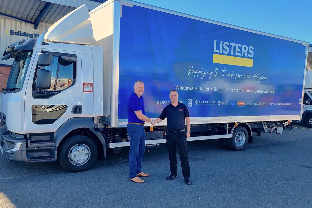 Two men standing in front of a new Listers branded lorry